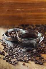 Freshly Brewed Coffee in Glass Cup with Coffee Beans on Table