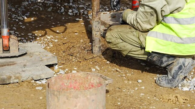 Close-up of soil sampling during pile drilling process. Extraction of subsurface material for geotechnical analysis and foundation assessment