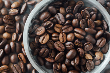Freshly Roasted Coffee Beans in Round Metal Bowl and Surrounding Beans