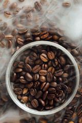 Fototapeta premium Freshly Roasted Coffee Beans in Round Silver Bowl on Table