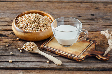 Fresh Soy Milk and Raw Soybeans on Wooden Table Background