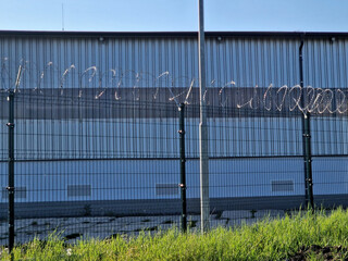 Barbed wire can also be mounted to the fence without using brackets. Stretch the barbed wire...