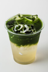 Refreshing Green Drink with Ice and Coconut Toppings for Summer