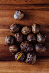 Roasted Chestnuts Piled on Wooden Surface Displaying Natural Texture