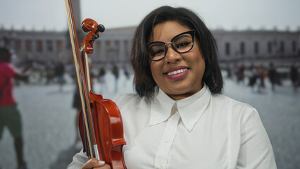 Woman smiling while holding a violin in a vibrant vatican city street, showcasing musical talent...