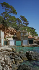 Mediterranean beach house nestled on cala llombards coast in mallorca bathed in sunlight against a...