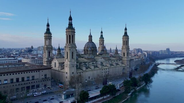 Aerial view of a historic city with a prominent cathedral and river.