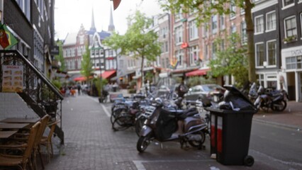 Blurred city street in amsterdam with bikes, outdoor cafes, and colorful flags, showcasing urban life and vibrant settings under a clear sky.