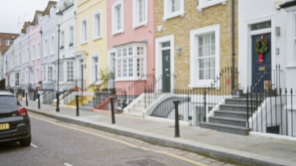 Defocused view of colorful houses and car on london street in winter season, encapsulating urban charm with pastel facades and iconic british architecture. © Krakenimages.com
