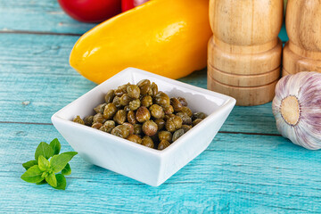 Pickled canned capers in the bowl