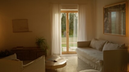 Blurred luxury living room with mediterranean style decor featuring neutral tones, soft lighting, and elegant furniture, conveying a serene indoor atmosphere.