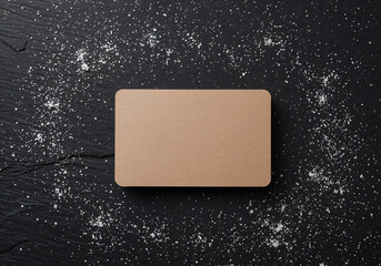 Kraft paper business card on black slate with flour powder decoration