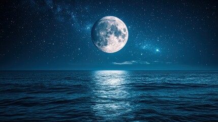 Full moon over a still ocean at night.  Vast expanse of dark blue water reflecting a large, pale, full moon, high in a star-studded night sky