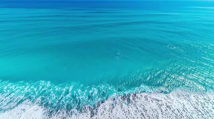Aerial drone view or top view perspective photography of a beautiful transparent clear sea or ocean waves and foam splashing on the dark navvy blue or gray sand beach