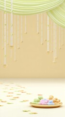 Elegant hanging decor over pastel-colored sweets and flowers on soft yellow background