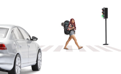 Asian female tourist crossing at pedestrian zebra with a backpack and smiling at camera