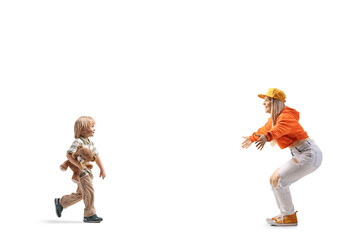 Boy with a teddy bear walking towards a young female