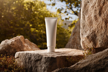Sunscreen tube stands prominently on rough stone surface, surrounded by natural greenery and soft sunlight, evoking sense of outdoor adventure and protection