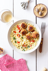 Orzo pasta with chicken meatballs, tomatoes and herbs. Italian food.