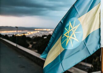 Close-up Ethiopia Flag Waving in the Wind. Evening background, In the capital of Ethiopia, city lights and road