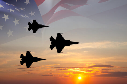 Fighter aircrafts with USA flag against the sunset sky
