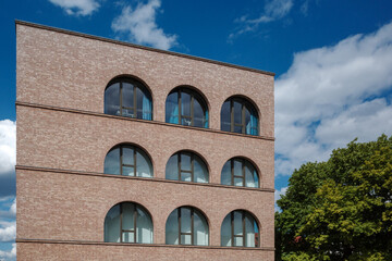 A low-angle view of a contemporary building in Berlin, Germany, constructed with light...