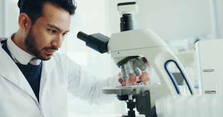 Science, laboratory and man with slide on microscope for analysis, medical research and study....