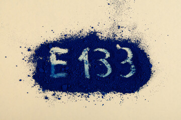 Powder of Brilliant blue FCF dye with inscription E133. Food additive E133 used as colorant for...