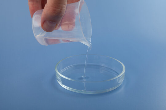 Silicone oil, also known as food additive E900. Dimethylpolysiloxane or dimethicone in Petri dish. Polydimethylsiloxane (PDMS) are a component of defoamers