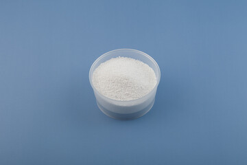 Benzoic acid or Carboxybenzene powder in plastic bowl. Other names: Dracylic acid, Benzoyl alcohol. Food additive E210, food preservative. Solid organic compound, chemical formula C7H6O2
