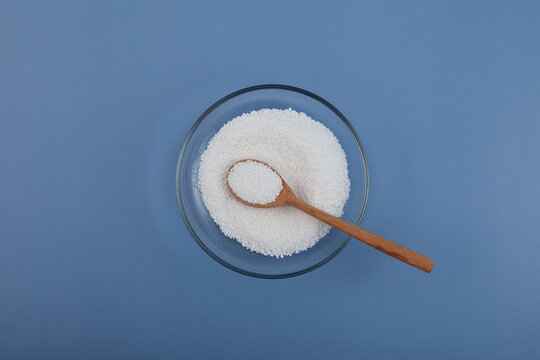 Food additive E210 in glass plate. Benzoic acid powder or Benzoylic acid. Other names: Carboxybenzene, Dracylic acid, Benzoyl alcohol. Preservative inhibits growth of mold, yeast and some bacteria