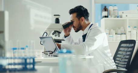 Scientist, analysis and man with microscope in lab for sample testing, clinical study and...