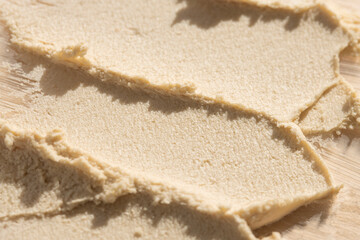 Texture of cosmetic cleansing body scrub, macro. Beige care product.