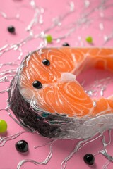 Closeup of Salmon Fillet on Pink Background with Silver Accents