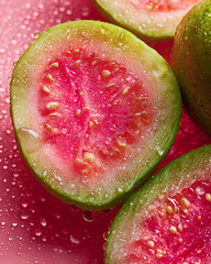 macro shot of halved guavas on a glossy wet surface