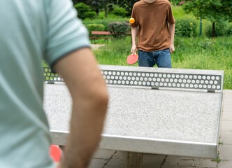 Table tennis in park. Ping pong summer sport outside, people play pingpong, table tennis game
