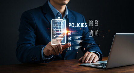Man in suit interacting with digital policies checklist on a laptop screen in a dark setting