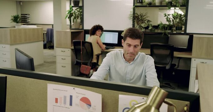 Glancing around male coworker packing helmet into backpack, pulling bike in office to commute