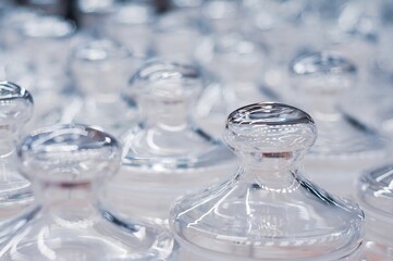 Close-up of clear glass jars arranged in a neat pattern with clean, minimalist aesthetic.