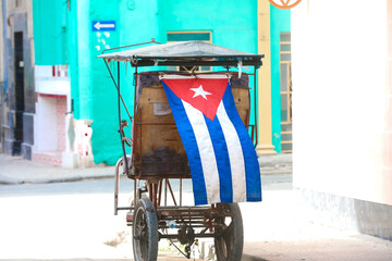 Cuban cycle taxi with Cuban flag,Cycle taxi in Old Havana, Cuba. Tricycle made into a taxi. Cheap transport bike for local and tourist in Havana