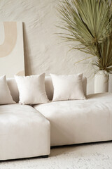 A spacious living area showcases a contemporary sectional sofa adorned with cushions, complemented...