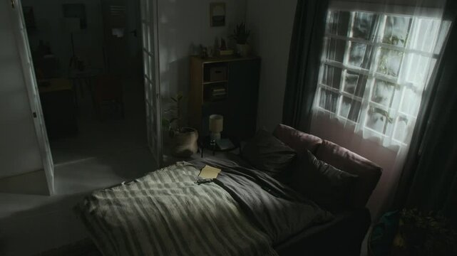 Wide angle shot of bedroom illuminated by lightning flashes then flickering light of lamps at late night while furniture start moving on its own, poltergeist concept