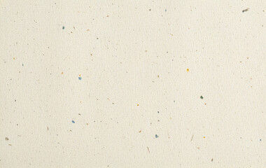 Light beige recycled paper texture with visible small fibers and flecks, slightly rough natural...