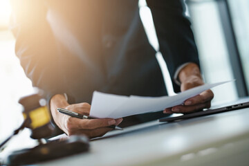 lawyer or judge counselor reading a important legal contract documents in office