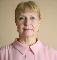 Portrait of a aged woman at the kitchen. Selective focus with shallow depth of field.