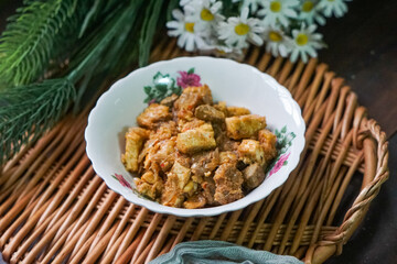 A bowl of Sambal Goreng Pengantin, a rich, traditional Malay dish made from a combination of beef liver, lung, trimmings, spleen, prawns, tofu, and tempe in coconut gravy, perfect for festive meals.

