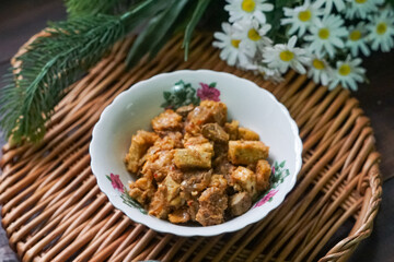 A bowl of Sambal Goreng Pengantin, a rich, traditional Malay dish made from a combination of beef liver, lung, trimmings, spleen, prawns, tofu, and tempe in coconut gravy, perfect for festive meals.
