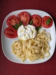 Spaghetti with tomato, burrata and basil
