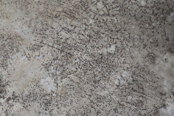 Close-up of a weathered concrete surface with rough texture and gray tones