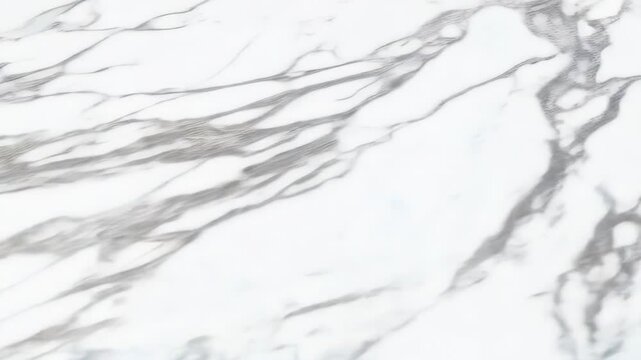 Close-up of smooth white marble texture with grey veining, showcasing elegant natural patterns for design applications.
